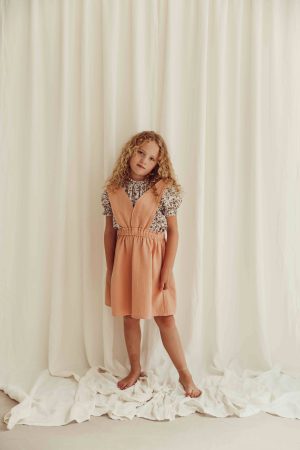 the organic cotton Josephine Blouse in Field Flowers paired with the Smilla skirt in Peach by the brand LiiLU