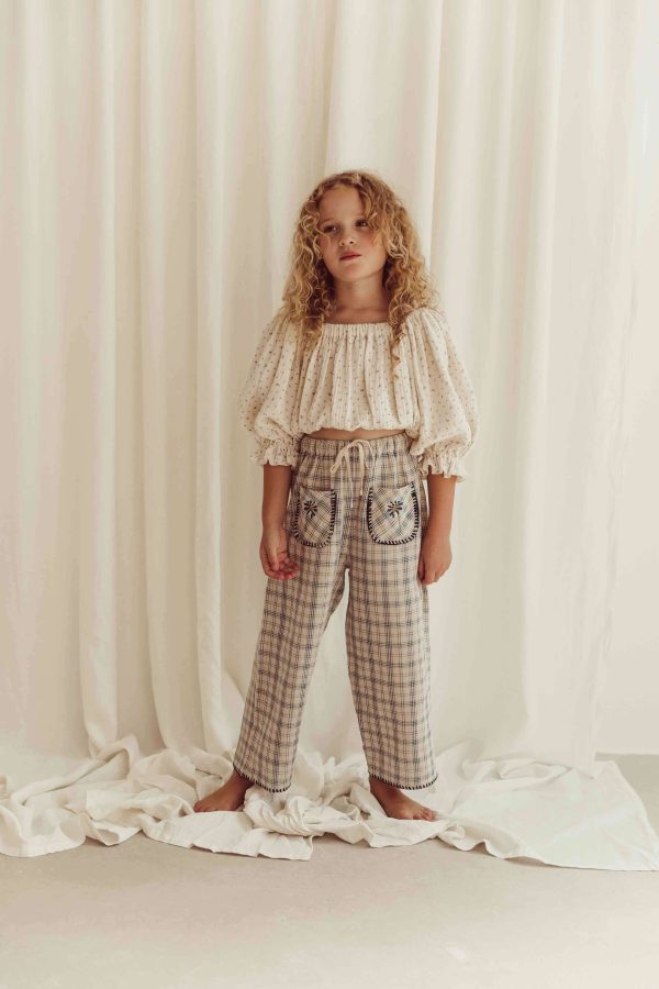 the organic cotton Leandra Blouse in Ditsy Floral paired with the Lilo Pants in Tattersall Check by the brand LiiLU