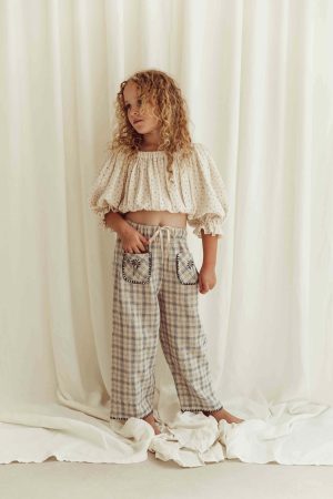 the organic cotton Leandra Blouse in Ditsy Floral paired with the Lilo Pants in Tattersall Check by the brand LiiLU