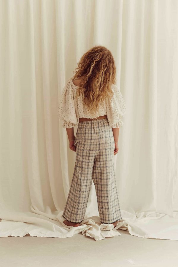 the organic cotton Lilo Pants in Tattersall check paired with the Leandra Blouse in Ditsy Floral by the brand LiiLU