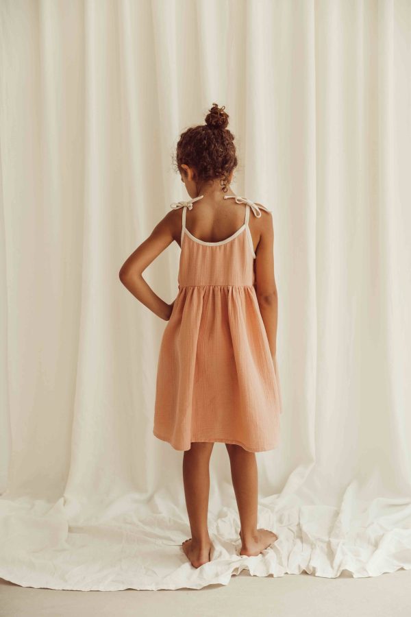the organic cotton Louisa Dress in peach by the brand LiiLU