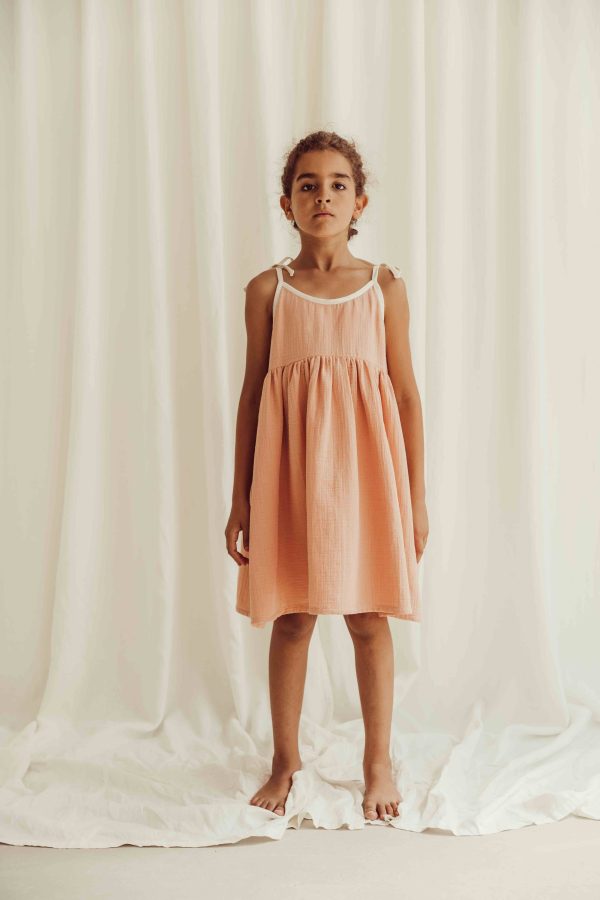 the organic cotton Louisa Dress in peach by the brand LiiLU