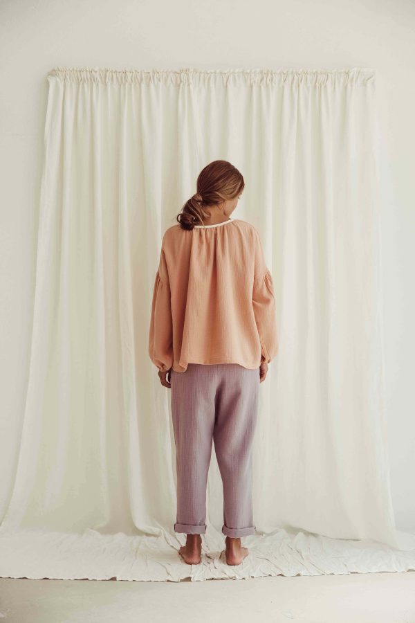 the organic cotton Lili Blouse in Peach paired with the Levi Pants in Lavender by the brand LiiLU