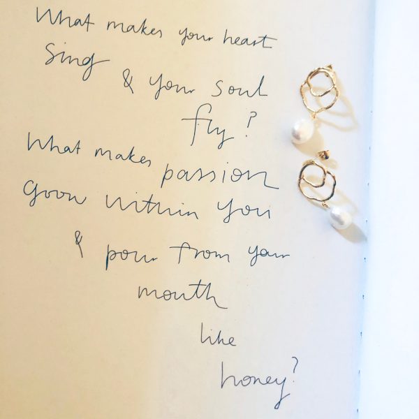 the golden & pearl Célaphine Earrings by the brand Agapé Studio shown on a page of the book 'Diary of a Freelancer' by Amanda Jones
