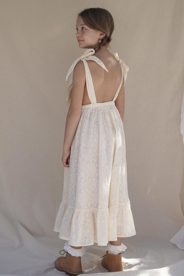 the Fiona Pinafore Dress in Creme Broderie by the brand House of Paloma, curated by Morsel Store