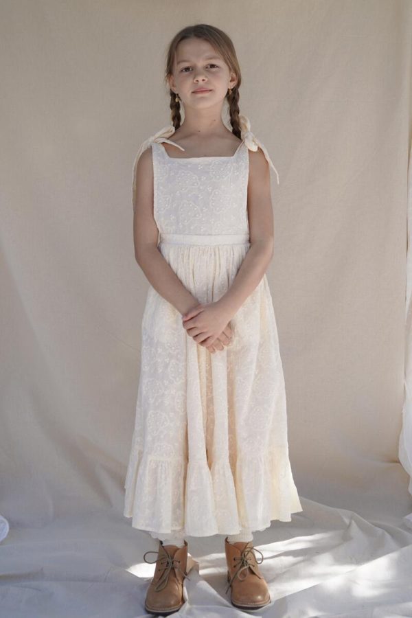 the Fiona Pinafore Dress in Creme Broderie by the brand House of Paloma, curated by Morsel Store