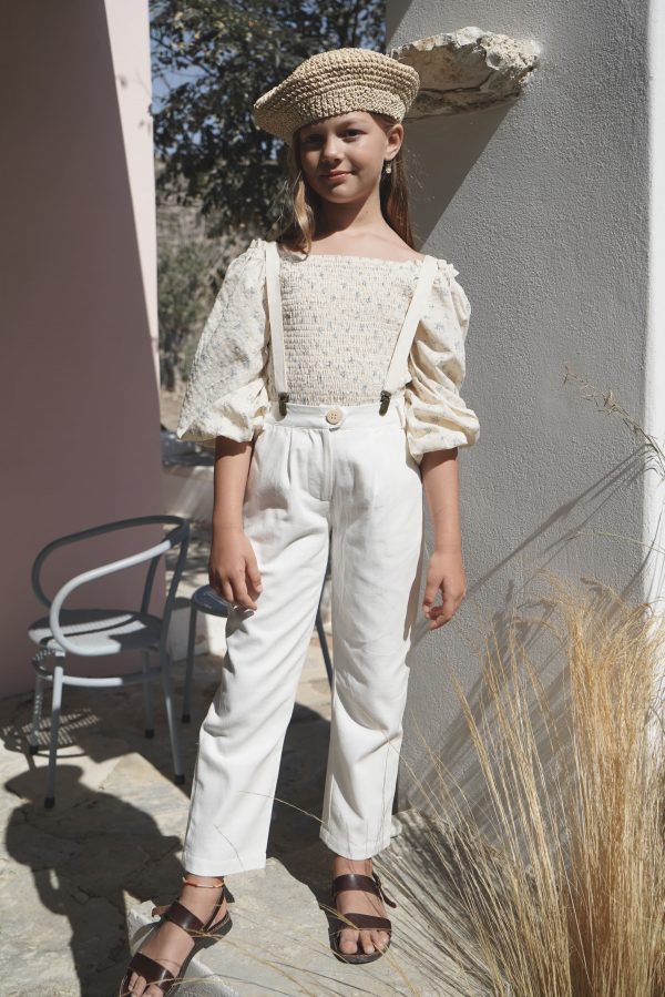 girl wearing the Lois Blouse in a floral Fleur Bleue cotton fabric, paired with the Jean Michel Pants by the sustainable brand House of Paloma, curated by Morsel Store