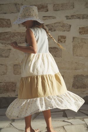 girl wearing the Valentina Dress in cotton melange paired with the Hydra Sun hat in a floral Fleur Bleue fabric by the sustainable brand House of Paloma, curated by Morsel Store