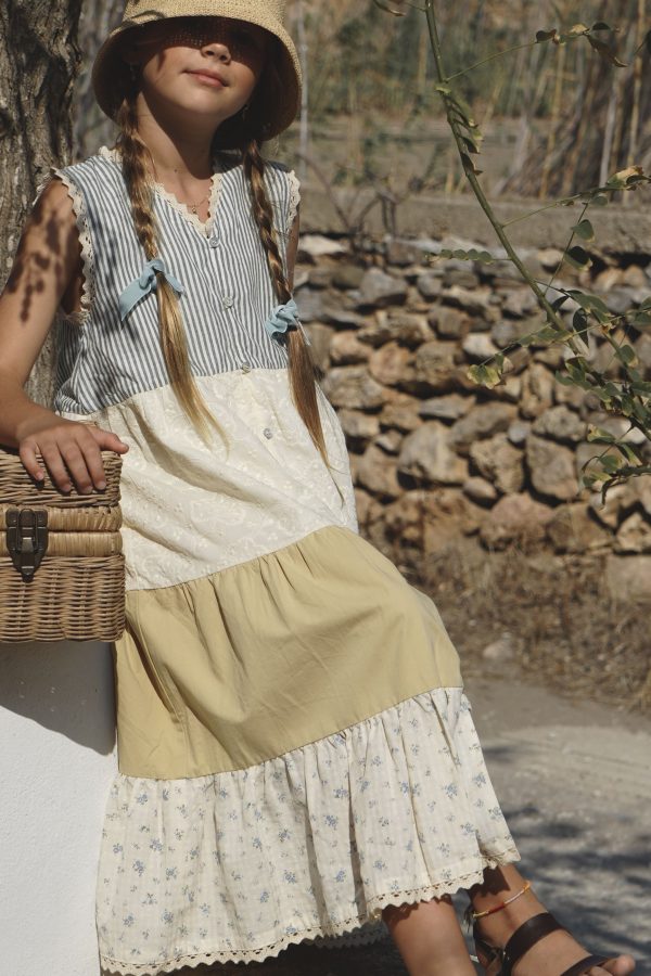 girl wearing the Valentina Dress in cotton melange paired with a raffia Sun hat by the sustainable brand House of Paloma, curated by Morsel Store