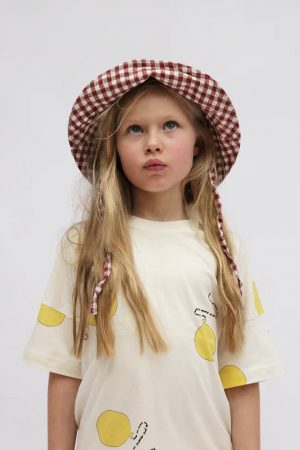 girl wearing the Oversized Tee in Natural with Balloon Print by the brand Summer and Storm, curated by Morsel Store