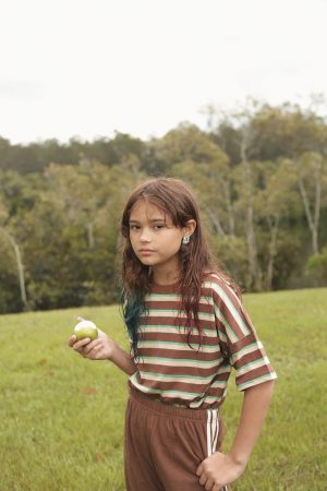 girl wearing the Oversized Tee in Brown Retro Stripe paired with the Racer Pants in Cocoa Brown by the brand Summer and Storm, curated by Morsel Store