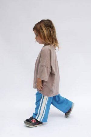 boy wearing the Oversized Tee in Mushroom paired with the Racer Pants in Sonic by the brand Summer and Storm, curated by Morsel Store
