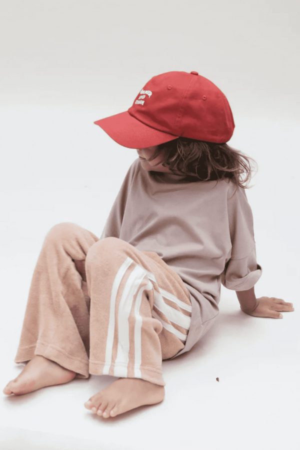 boy wearing the Oversized Tee in Mushroom paired with the Racer Terry Pants in Peach by the brand Summer and Storm, curated by Morsel Store