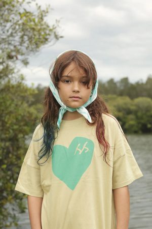 girl wearing the Oversized Tee in SS Green Heart by the brand Summer and Storm, curated by Morsel Store