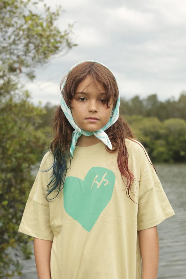 girl wearing the Oversized Tee in SS Green Heart by the brand Summer and Storm, curated by Morsel Store