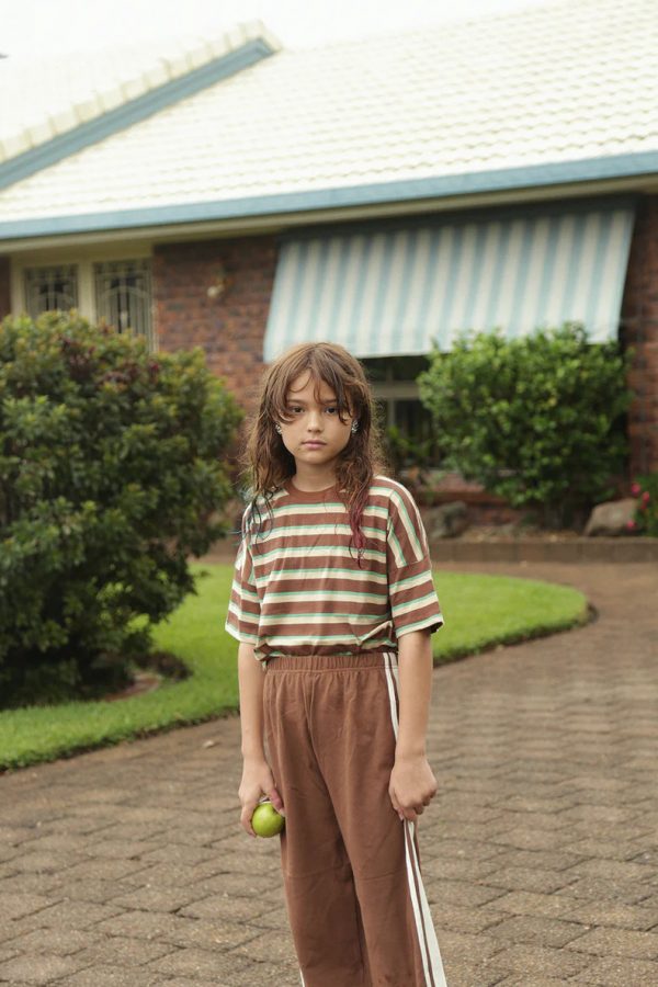 girl wearing the Racer Pants in Cocoa Brown paired with the Oversized Tee in Brown Retro Stripe by the brand Summer and Storm, curated by Morsel Store