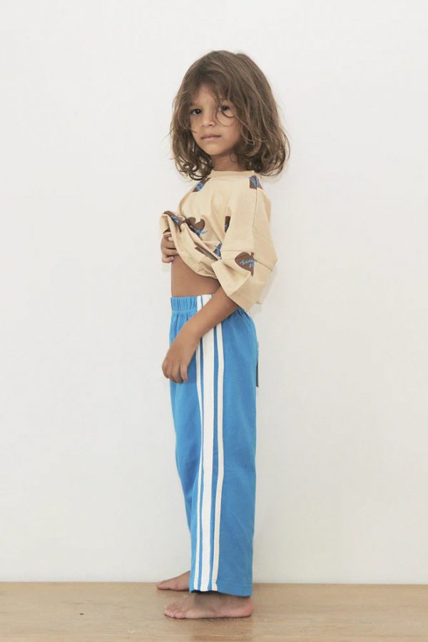 boy wearing the Racer Pants in Sonic Blue paired with the Oversized Tee in SS Hearts by the brand Summer and Storm, curated by Morsel Store