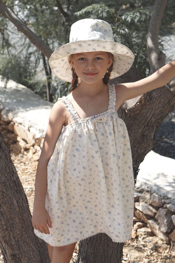 the cotton Daphne Dress in Fleur Bleue paired with the matching Hydra Hat by the brand House of Paloma, curated by Morsel Store
