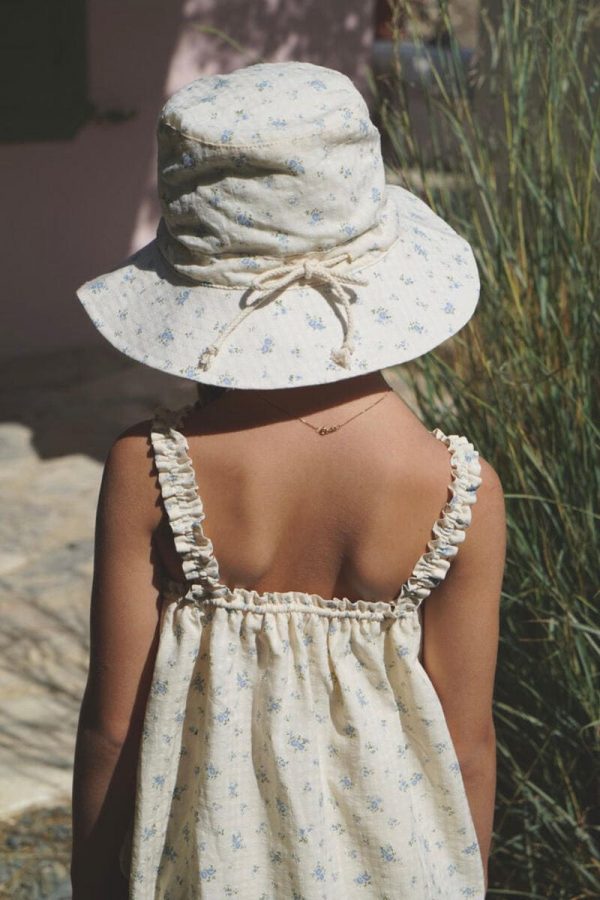girl wearing the Hydra Sun Hat in a floral Fleur Bleue cotton fabric, paired with the matching Daphne Dress by the sustainable brand House of Paloma, curated by Morsel Store