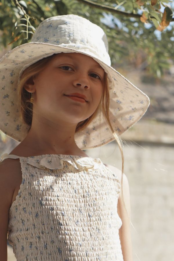 girl wearing the Hydra Sun Hat in a floral Fleur Bleue cotton fabric, paired with the matching Rosa One Piece Swim Suit by the sustainable brand House of Paloma, curated by Morsel Store