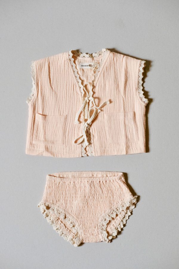 the Pasquelina Vest in muslin Peach Sorbet fabric with the matching Agnes Set bikini bottoms by the sustainable brand House of Paloma, curated by Morsel Store