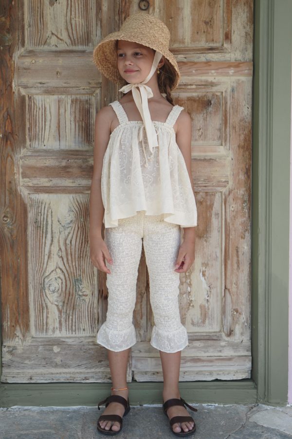 girl wearing the Zadie Pant & matching Edith Top in Creme Broderie cotton, paired with the Jean Belle Hat, by the sustainable brand House of Paloma, curated by Morsel Store