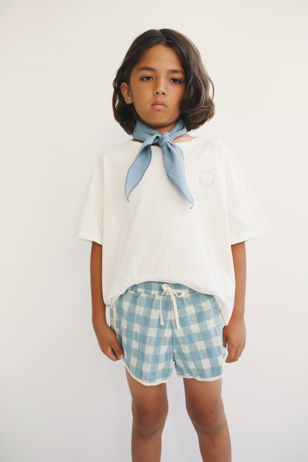 boy wearing the Swim Shorts in Blue/Tea by the sustainable brand LiiLU, curated by Morsel Store, located on Mallorca