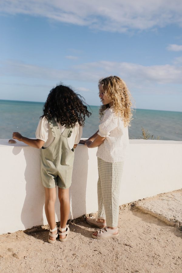 girl wearing the Remy Pant in Tea organic cotton paired with the Oana Blouse by the sustainable brand LiiLU. Curated by Morsel Store, located on Mallorca