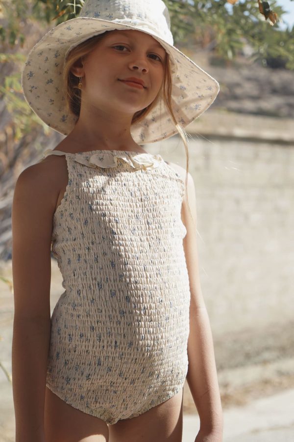 girl wearing the cotton Rosa One-Piece Swimsuit in Fleur Bleue paired with the matching Hydra Hat by the sustainable brand House of Paloma, curated by Morsel Store
