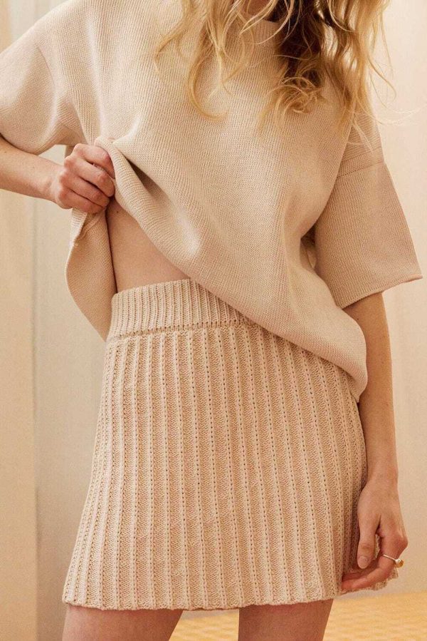 the hand knitted Lapas Mini Skirt in Oat Milk paired with the matching Aistis Tshirt by the brand The Knotty Ones, curated by Morsel Store