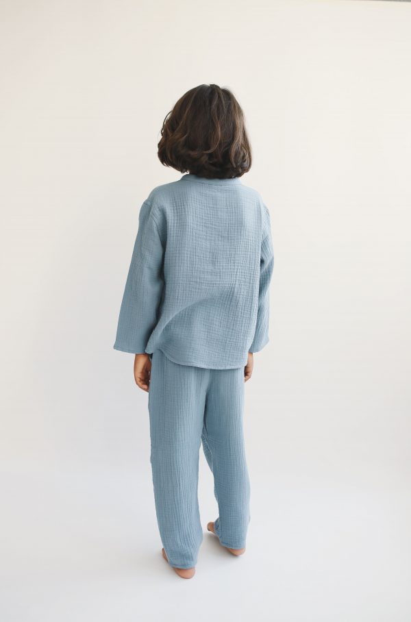 boy wearing the Levi Pant in Storm Blue organic muslin cotton paired with the Leonard Shirt by the sustainable brand LiiLU, curated by Morsel Store located on Mallorca