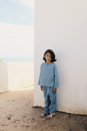 boy wearing the Levi Pant in Storm Blue organic muslin cotton paired with the Leonard Shirt by the sustainable brand LiiLU, curated by Morsel Store located on Mallorca