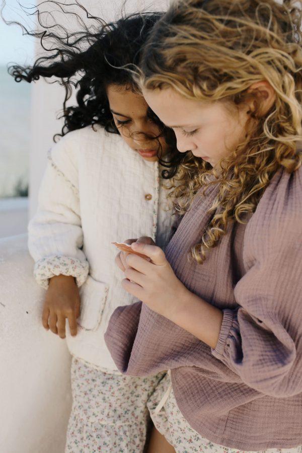 girl wearing the Liilu Blouse in Pale Mauve organic muslin cotton by the sustainable brand LiiLU, curated by Morsel Store located on Mallorca