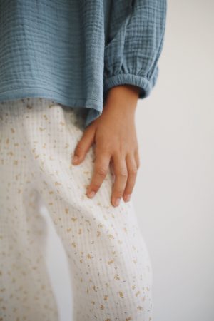 girl wearing the Liilu Blouse in Storm Blue organic muslin cotton by the sustainable brand LiiLU, curated by Morsel Store located on Mallorca