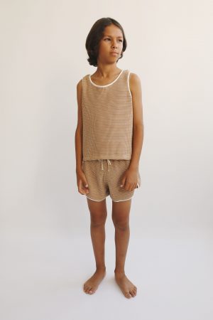 boy wearing the Bobo Top in Chestnut Organic Cotton paired with the matching Dayo Shorts by the sustainable brand Liilu, curated by Morsel Store, located on Mallorca