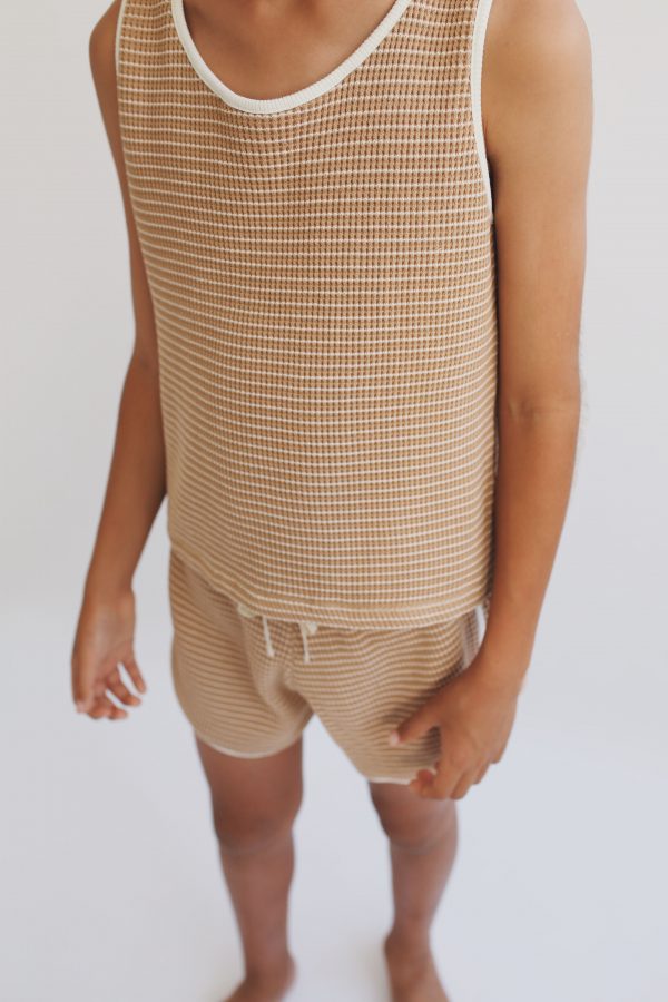 boy wearing the Bobo Top in Chestnut Organic Cotton paired with the matching Dayo Shorts by the sustainable brand Liilu, curated by Morsel Store, located on Mallorca