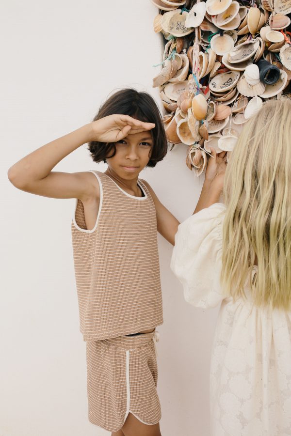 boy wearing the Dayo Shorts in Chestnut organic cotton paired with the matching Bobo Top by the sustainable brand Liilu, curated by Morsel Store, located on Mallorca
