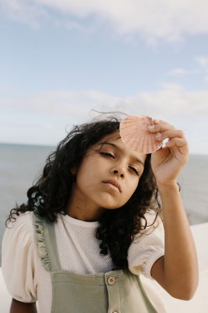 girl wearing the Jala Blouse in Ecru organic cotton paired with the matching Kaya Playsuit by the sustainable brand LiiLu, curated by Morsel Store, located on Mallorca