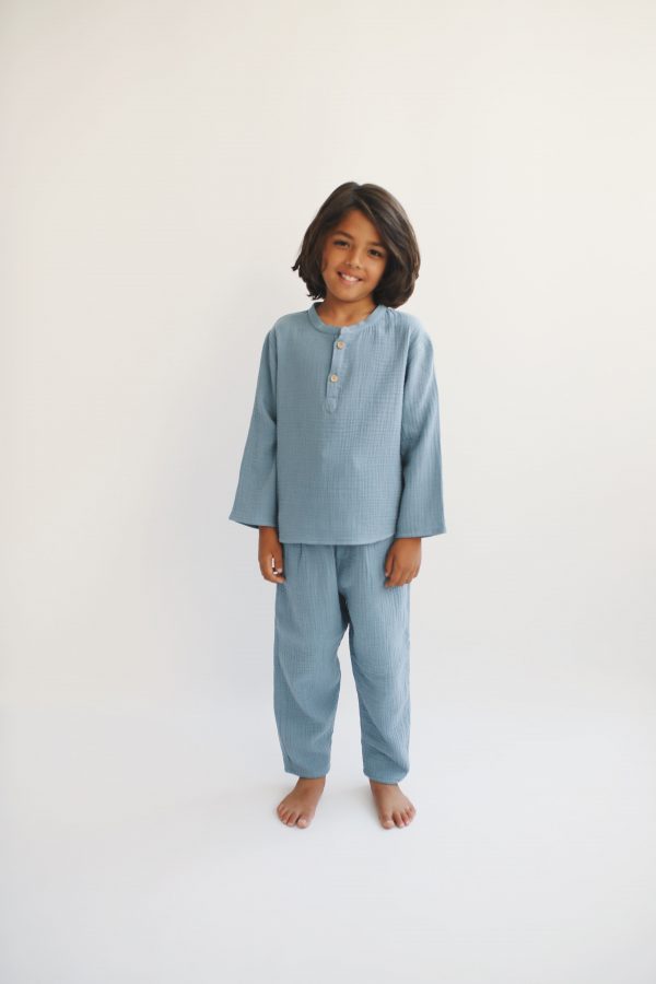 boy wearing the Leonard Shirt in Storm blue organic muslin cotton paired with the matching Levi Pant by the sustainable brand LiiLU, curated by Morsel Store located on Mallorca