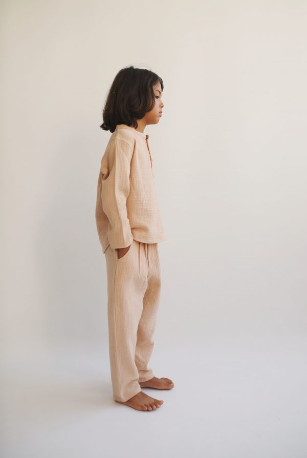 boy wearing the Levi Pant in Nude organic muslin cotton paired with the Leonard Shirt by the sustainable brand LiiLU, curated by Morsel Store located on Mallorca