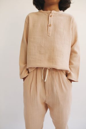 boy wearing the Levi Pant in Nude organic muslin cotton paired with the Leonard Shirt by the sustainable brand LiiLU, curated by Morsel Store located on Mallorca