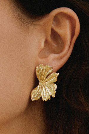 woman wearing the Donis Earrings in gold by the sustainable brand Agapé Studio, curated by Morsel Store