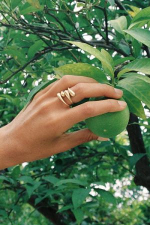 woman wearing the Filippa Ring in gold (stacked) by the sustainable jewellery brand Agapé Studio, curated by Morsel Store