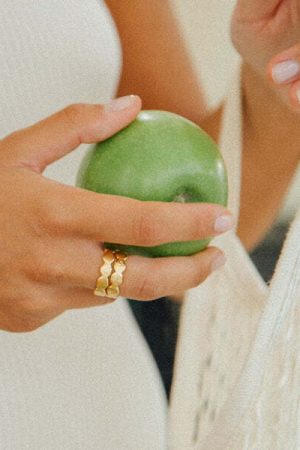 woman wearing the Francesca Ring in gold by the sustainable jewellery brand Agapé Studio, curated by Morsel Store