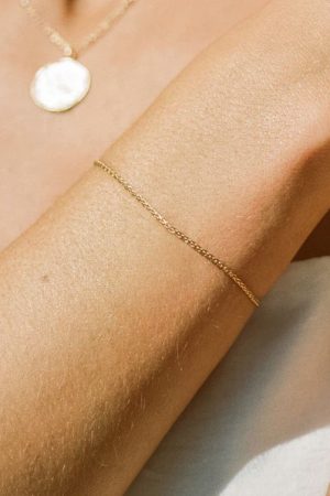 woman wearing the Loulo Bracelet in gold by the sustainable jewelry brand Agapé Studio, curated by Morsel Store