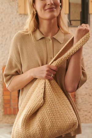 woman wearing the cotton Pintiné Crochet Bag in dark wheat by the sustainable brand The Knotty Ones, curated by Morsel Store
