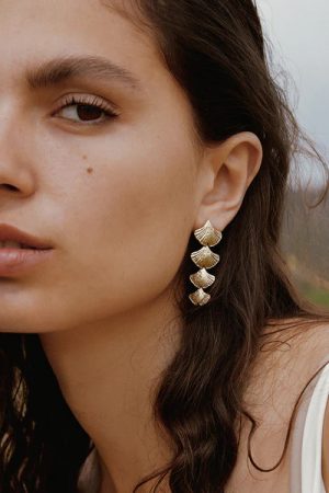 woman wearing the Biloba Earrings in gold by the sustainable jewelry brand Agapé Studio (now Agapée), curated by Morsel Store