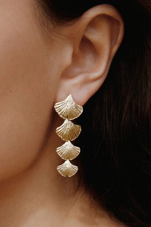 woman wearing the Biloba Earrings in gold by the sustainable jewelry brand Agapé Studio (now Agapée), curated by Morsel Store