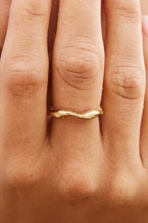 woman wearing the Satis Ring in gold by the sustainable jewelry brand Agapé Studio (now Agapée), curated by Morsel Store