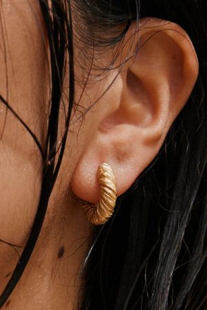 woman wearing the Zeta Earrings in gold by the sustainable jewelry brand Agapé Studio (now Agapée), curated by Morsel Store